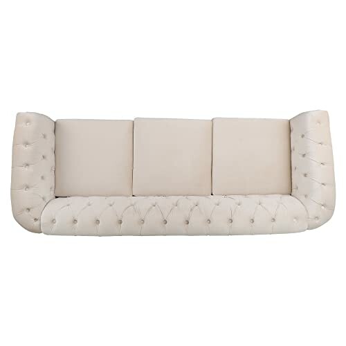 Beige tufted sofa with three cushions.